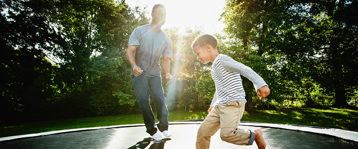 Man and child on a trampoline